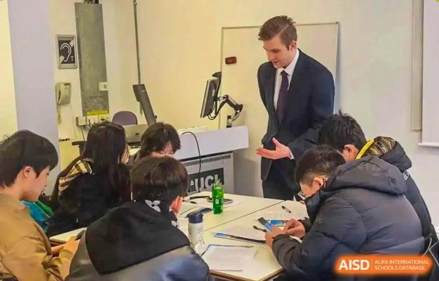Chengdu No.7 High School International Department students engaging in a discussion with an international teacher or guest speaker.