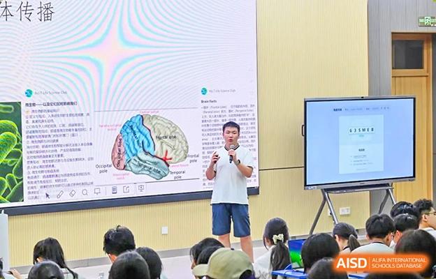 Teacher or lecturer at Chengdu No.7 High School International Department giving a presentation on brain anatomy and biology to students.
