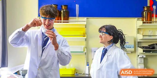 Two students from Harrow International School Beijing (AISL Beijing) are collaborating on a science project in the lab.
