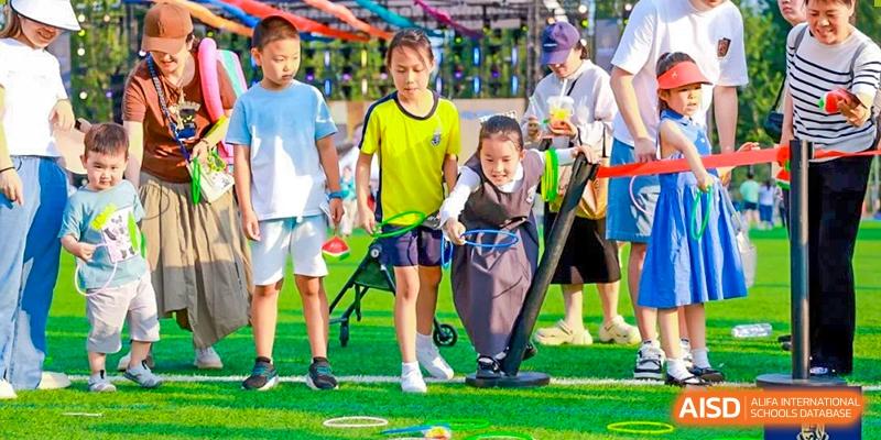 A group of Harrow International School Beijing (AISL Beijing) students are participating in an outdoor field game.