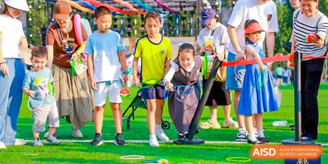 A group of Harrow International School Beijing (AISL Beijing) students are participating in an outdoor field game.
