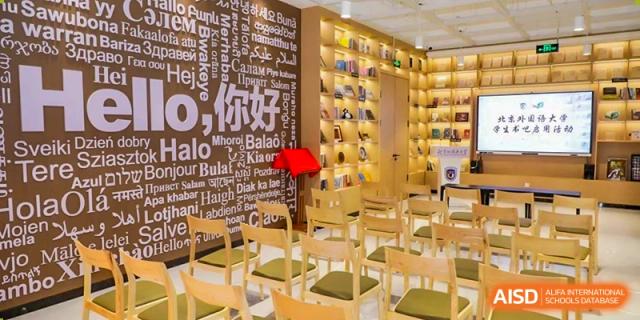 An inviting study area or library with wooden chairs, bookshelves, and a decorated wall at BEIJING CHAOYANG TONGWEN FOREIGN LANGUAGE SCHOOL.