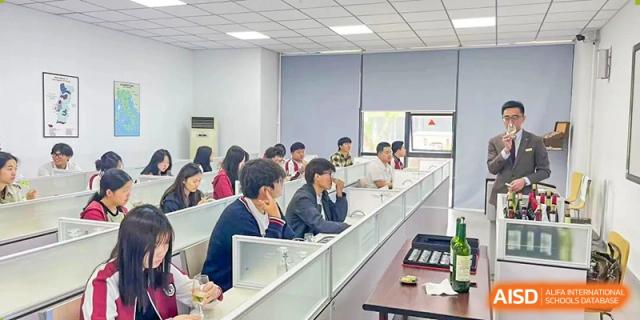 Students and faculty members attending a formal meeting or seminar in a conference room at BEIJING CHAOYANG TONGWEN FOREIGN LANGUAGE SCHOOL.