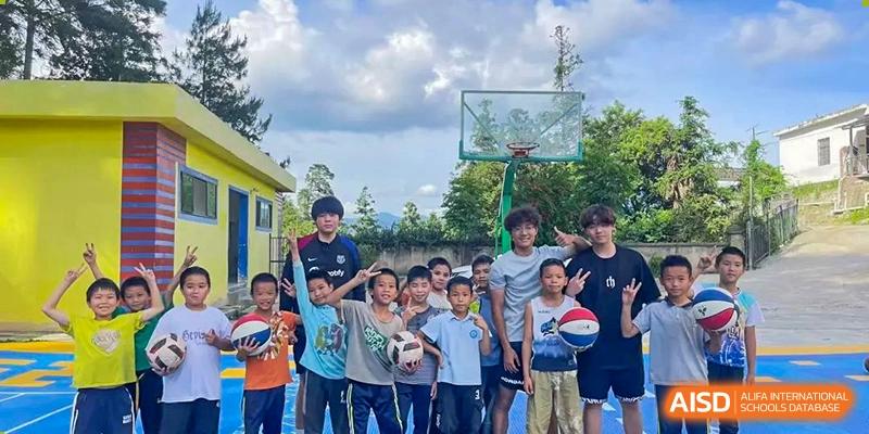 A group of male students posing together on a sports court next to a basketball hoop at BEIJING CHAOYANG TONGWEN FOREIGN LANGUAGE SCHOOL.