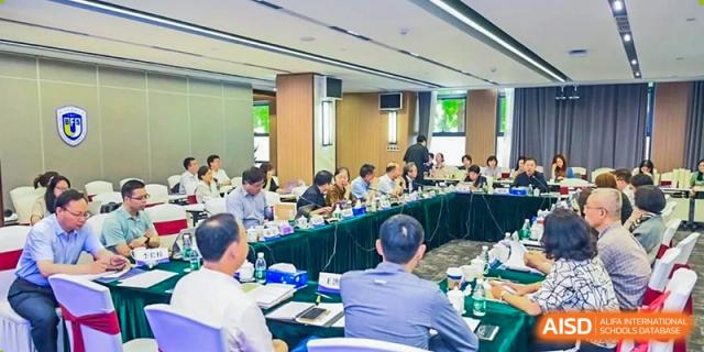 Faculty or staff members from BEIJING CHAOYANG TONGWEN FOREIGN LANGUAGE SCHOOL attending a meeting in a conference room.