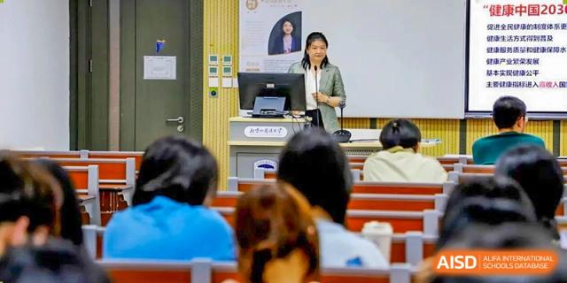 A photo showing a teacher standing in front of the students and teaching, at Beijing Foreign Studies University International Curriculum Center.