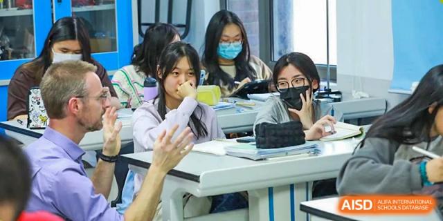 A photo showing a group of students in a classroom. They are having a lecture, at Beijing Foreign Studies University International Curriculum Center.