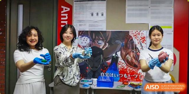 A photo showing a female student doing a scientific experiment, at Beijing Foreign Studies University International Curriculum Center.