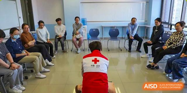 A photo showing students in a class. A teacher is teaching them health and nutrition, at Beijing Foreign Studies University International Curriculum Center.