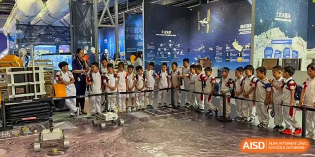 Students from Shijingshan School of The High School Affiliated to Renmin University of China play an interactive video game on a large screen.