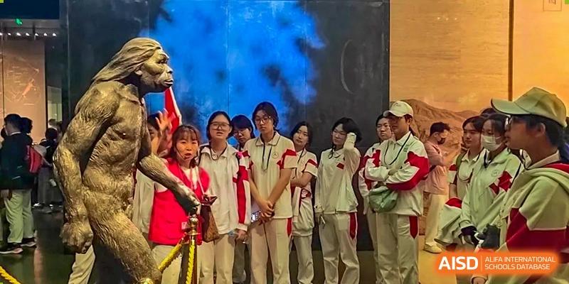 Students from Shijingshan School of The High School Affiliated to Renmin University of China, wearing white and red uniforms, stand in a group.
