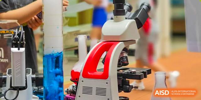 Close-up of a modern white and red microscope used for science experiments in the school lab. Beanstalk International Bilingual School (BIBS) - Chengdu