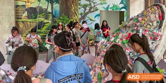 Students exploring a creative indoor exhibit with wall murals and artistic installations. Beanstalk International Bilingual School (BIBS) - Chengdu