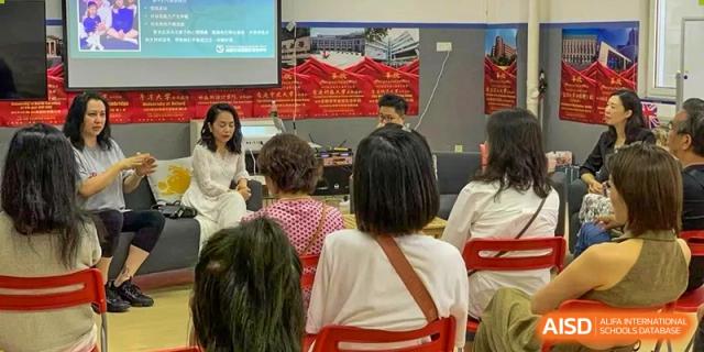 An audience of parents and staff listening to a speaker during an indoor school presentation or seminar. Beanstalk International Bilingual School (BIBS) - Chengdu