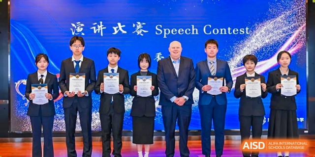 Winners of a Speech Contest at The Experimental School Affiliated with Zhuhai No.1 High School posing with certificates and an adult representative.