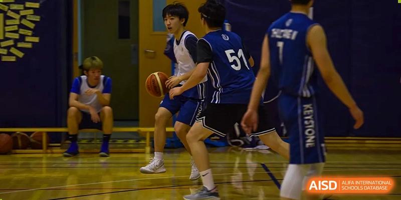Beijing Keystone Academy boys basketball players in action during a game.