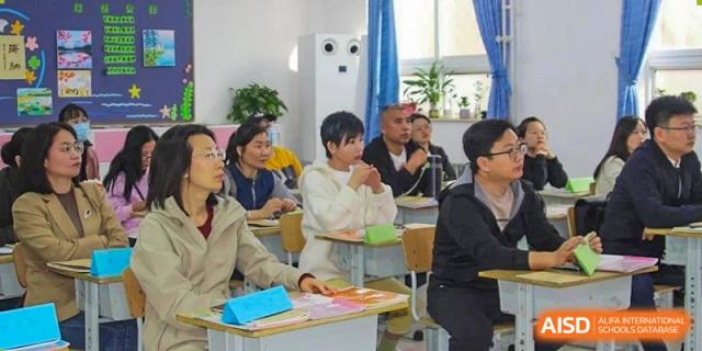 Students at Beijing Zhongguancun Foreign Language School listening to a lesson in a classroom.