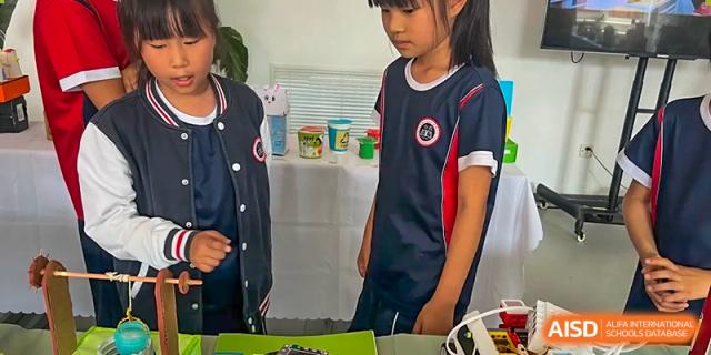 Two Beijing Zhongguancun Foreign Language School students collaborating on a school project.