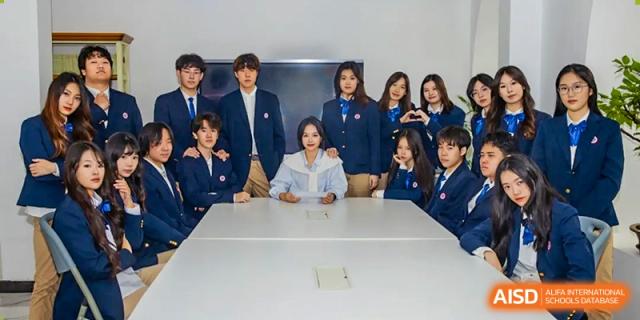 A group of Beijing Zhongguancun Foreign Language School students posing for a group photo.
