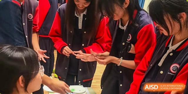 Two Beijing Zhongguancun Foreign Language School students working on a science project.