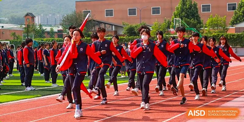 A photo showing a group of students participating in a running race, at Beijing Zhongguancun Foreign Language School.