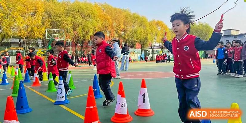 A photo showing students participating in an outdoor activity with cones, at Beijing Zhongguancun Foreign Language School.