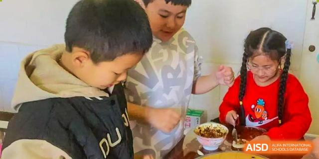 A Beijing Zhongguancun Foreign Language School student serving himself food in the cafeteria.