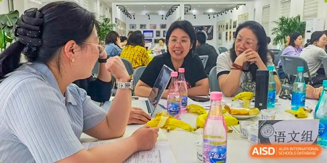 A group of Beijing Zhongguancun Foreign Language School adults and students eating in the cafeteria.