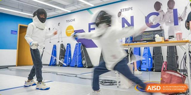 A student from Chiway Bilingual School Xiamen engaged in a fencing match in a dedicated sports hall.