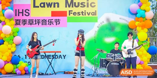 A female student from Chiway Bilingual School Xiamen singing and performing with a microphone during a music festival.