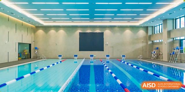 The clean, well-lit lanes of an indoor swimming pool facility at Chiway Bilingual School Xiamen.