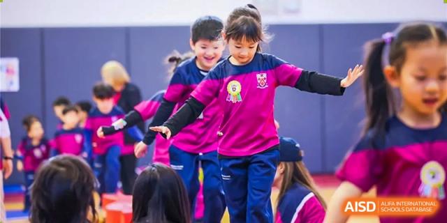 Young students from Dulwich College Beijing are participating in a group activity or performance.