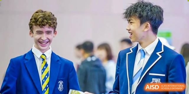 Students from Harrow International School Shanghai gathered together, looking at someone off-camera.
