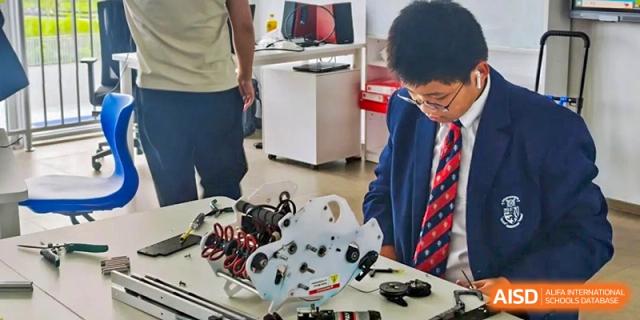 Students from Harrow International School Shanghai working on a robotics project.