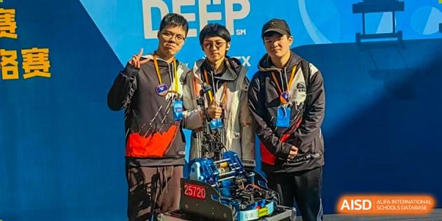 A group of male students from Harrow International School Shanghai posing with their robotics project at a competition.