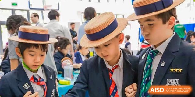 A male student from Harrow International School Shanghai wearing a boater hat.