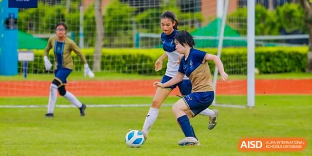 Two students from Harrow International School Shanghai playing soccer during a game.
