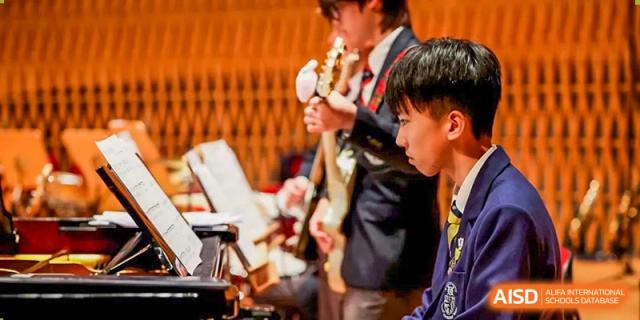 Students from Harrow International School Shanghai playing brass instruments in an orchestra.