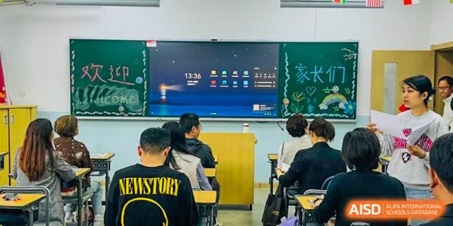 Students in a classroom working while a large digital screen displays the time and a "HISTORY" prompt at The No.2 High School Of East China Normal University (HSEFZ).