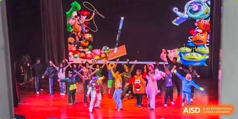 Young students performing a colorful dance or parade on a brightly lit stage at a school event at The No.2 High School Of East China Normal University (HSEFZ).