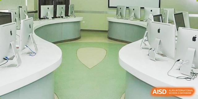 A classroom or lab with white, heart-shaped floor patterns and modern furniture at the International Curriculum Center of RDFZ.
