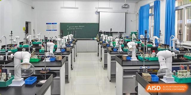 A clean and modern science laboratory with lab equipment on the tables and a whiteboard at the International Curriculum Center of RDFZ.