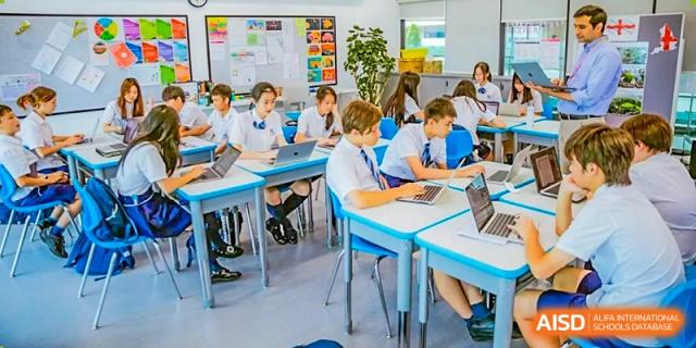 Students from ISA Science City International School are working on laptops in a classroom.