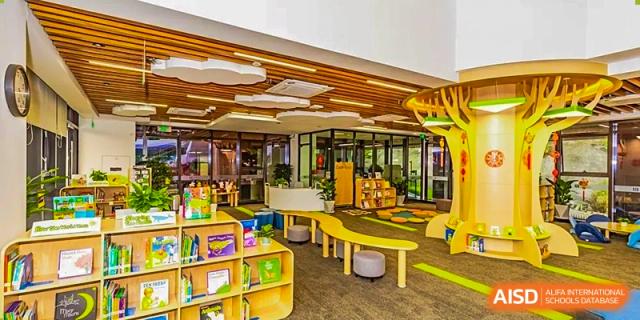 An indoor common area with modern, colorful furniture is shown at ISA Science City International School.