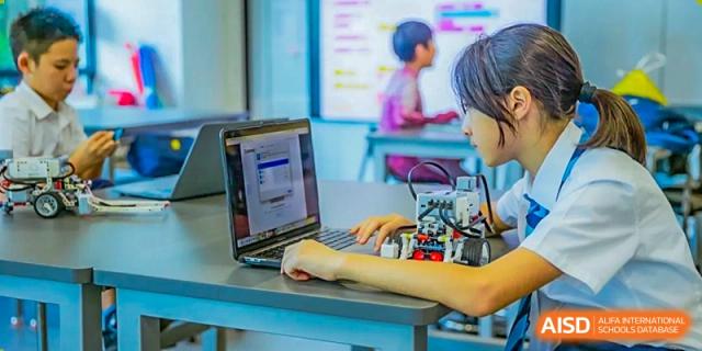 A student from ISA Science City International School is using a laptop in a classroom.