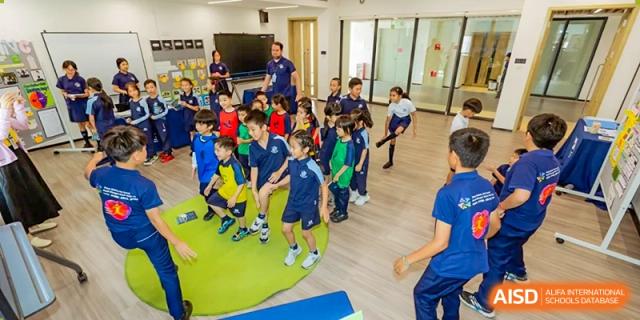 Students from ISA Science City International School are lined up with their teacher, getting ready to play a game.