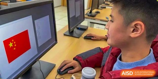 A NANJING THOMAS SCHOOL student is using a computer in a computer lab.