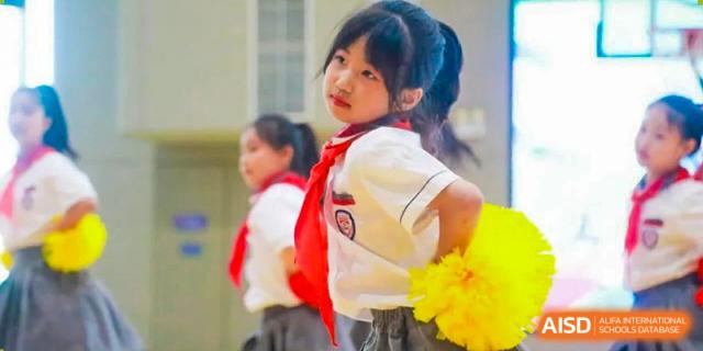 A young NANJING THOMAS SCHOOL student in uniform is smiling at the camera.