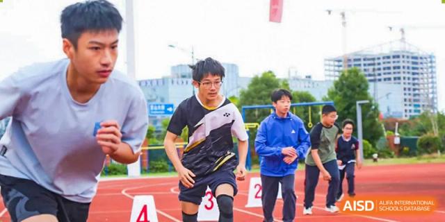 A NANJING THOMAS SCHOOL student is running a race on a sports track.
