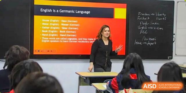 A teacher from Rugao International Academy BFSU giving a presentation to students.
